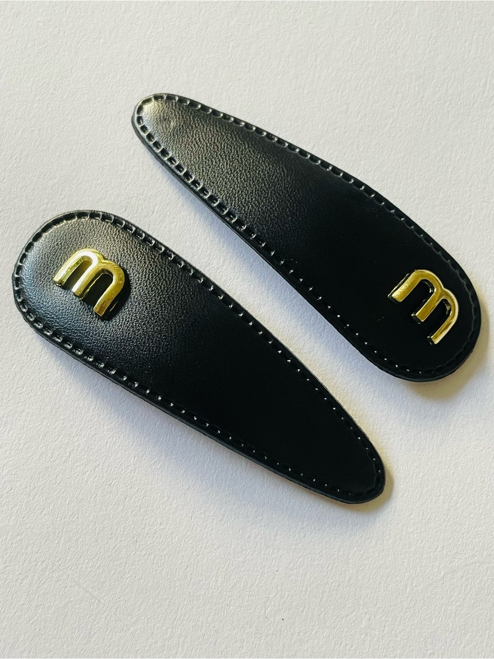 Black and gold logo hair clips barrettes